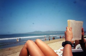 Tash reading on the beach